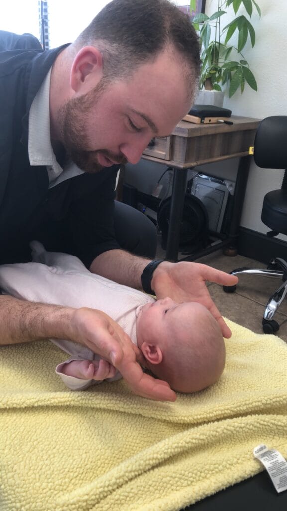 dr keeton performing pediatric chiropractic care on infant